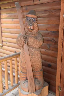 a statue of a bear holding a pair of skis at Tuolumne Meadow in Wawona