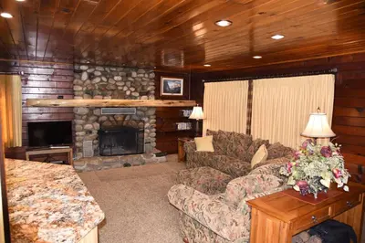 a living room with a couch and a fireplace at Tuolumne Meadow in Wawona