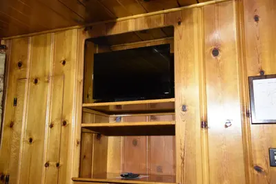 a tv in a wooden wall with a television in it at Tuolumne Meadow in Wawona