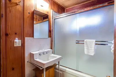 a bathroom with a sink and a shower at Creekside Cabin in Wawona