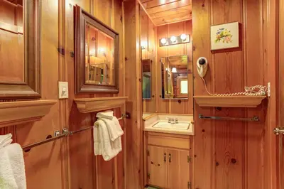 a bathroom with a sink and a mirror at Hansen Cabin in Wawona