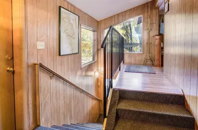 a staircase in a home with wooden walls and wooden floors at River Lodge in Wawona