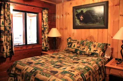 a bedroom with a bed and a window at Grizzly Giant in Wawona