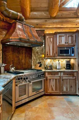 a kitchen with wooden cabinets and a stove top oven at El Capitan in Wawona