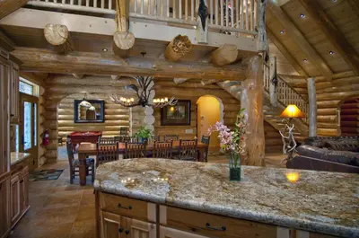 a kitchen and dining room of a log cabin at El Capitan in Wawona