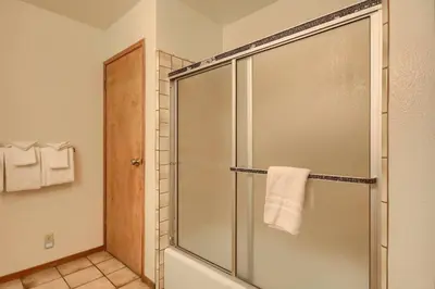 a bathroom with a shower with a glass door at Bordentown West in Wawona
