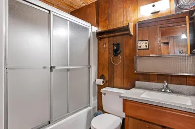a bathroom with a shower and a toilet and a sink at Meadow View in Wawona