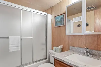 a bathroom with a shower and a toilet and a sink at Meadow View in Wawona
