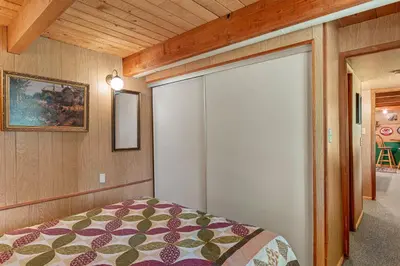 a bedroom with a bed and a sliding glass door at Meadow View in Wawona
