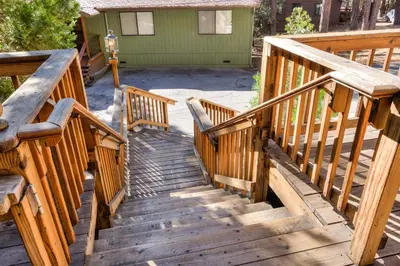 a set of wooden stairs in front of a house at Cedar Lodge in Wawona