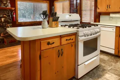a kitchen with a stove and a counter top at Simmons Den in Wawona
