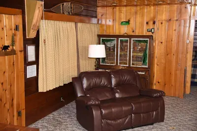 a brown leather chair in a room with a window at Sequoia in Wawona