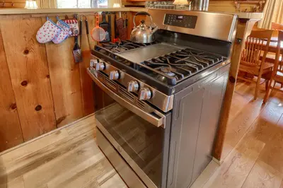 a kitchen with a stove with a tea kettle on it at Walk-A-Bout in Wawona