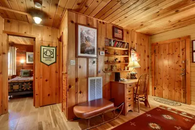 a room with a desk and a bed in a cabin at Walk-A-Bout in Wawona