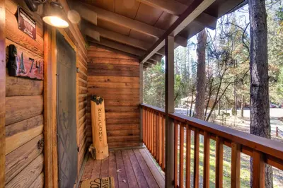 a porch of a cabin with wooden walls and ceilings at Our Yosemite Getaway in Wawona
