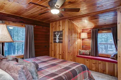 a bedroom with a bed and a ceiling fan at Our Yosemite Getaway in Wawona