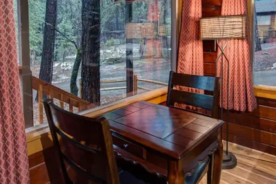 a table and chair in a room with a window at Our Yosemite Getaway in Wawona