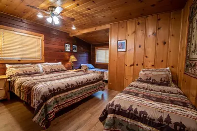 a bedroom with two beds and a ceiling fan at Howard's Retreat in Wawona