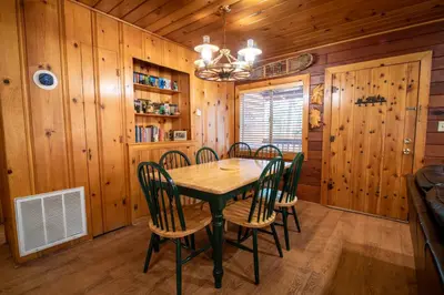 a dining room with a table and chairs in a cabin at Howard's Retreat in Wawona