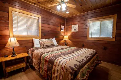 a bedroom with a bed and two lamps on a table at Howard's Retreat in Wawona