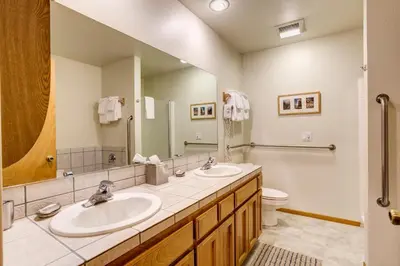 a bathroom with two sinks and a toilet at Miller's Landing in Wawona