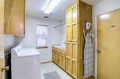 a kitchen with a washer and dryer next to a door at Miller's Landing in Wawona