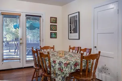 a dining room with a table and chairs at Ashbaugh Meadow in Wawona