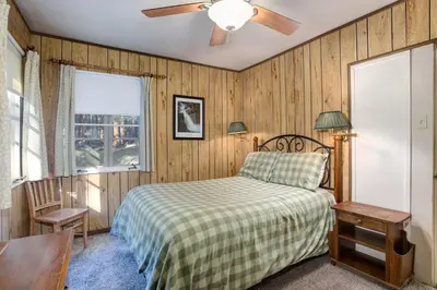 a bedroom with a bed and a ceiling fan at Ashbaugh Meadow in Wawona