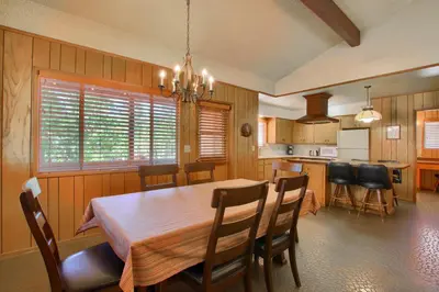a kitchen and dining room with a table and chairs at Hasting's Hideaway in Wawona