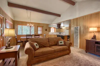 a living room with a couch and a dining room at Hasting's Hideaway in Wawona