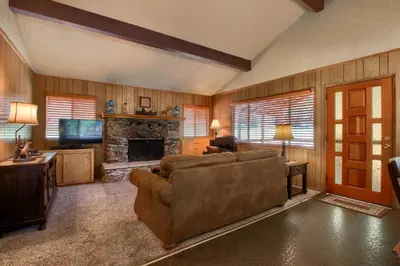 a living room with a couch and a fireplace at Hasting's Hideaway in Wawona