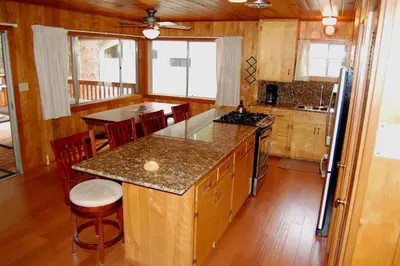 a kitchen with a center island in a house at Harmony Villa in Wawona