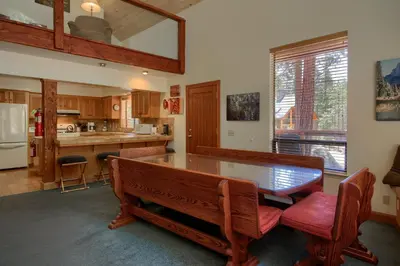 a kitchen with a table and chairs and a counter at Jolie Cabin in Wawona