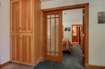 a room with a door leading to a bedroom at Jolie Cabin in Wawona