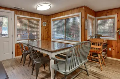 a dining room with a table and chairs at The Little Creek Cabin in Wawona