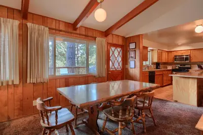 a kitchen with a large wooden table and chairs at Yosemite Mountain Lodge in Wawona