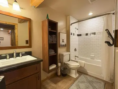a bathroom with a sink and a toilet and a tub at Lily of the Valley - Big Wall, Yosemite Day Use Reservations, Breakfast, Forest View and WiFi in Yosemite West