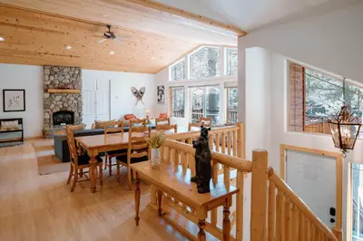 a dining room with a table and a fireplace at Beautiful and Spacious Home - Walk to Lake & Beach in Tahoma