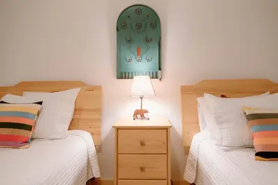 a bedroom with two beds and a lamp on a night stand at Beautiful and Spacious Home - Walk to Lake & Beach in Tahoma