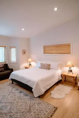 a bedroom with a large white bed and two lamps at Beautiful and Spacious Home - Walk to Lake & Beach in Tahoma