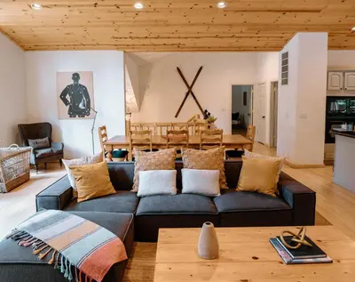 a living room with a couch and a table at Beautiful and Spacious Home - Walk to Lake & Beach in Tahoma