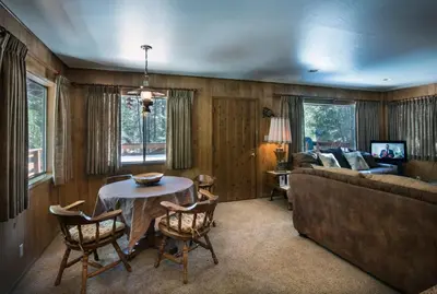 a living room with a table and a couch at Arnetts' Cabin in Wawona