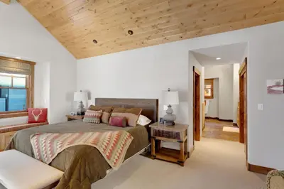 a bedroom with a large bed and a wooden ceiling at 4BR Cabin with Hot Tub – Ultimate Truckee Escape cabin in Truckee