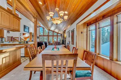 a dining room with a wooden table and chairs at Handcrafted Tahoe Retreat Walk to Beach & Ski in Tahoe City