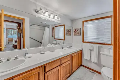 a bathroom with a sink and a toilet and a mirror at Handcrafted Tahoe Retreat Walk to Beach & Ski in Tahoe City
