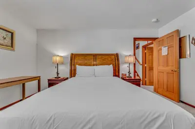 a bedroom with a large white bed and two lamps at Handcrafted Tahoe Retreat Walk to Beach & Ski in Tahoe City
