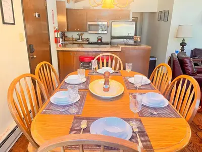 a wooden table with chairs and a dining room at ManVee at Yosemite in Fish Camp