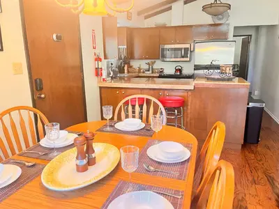 a dining room table with chairs and a kitchen at ManVee at Yosemite in Fish Camp