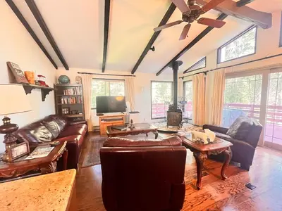 a living room with leather furniture and a flat screen tv at ManVee at Yosemite in Fish Camp