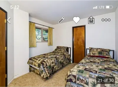 a bedroom with a bed and a bed and a window at ManVee at Yosemite in Fish Camp